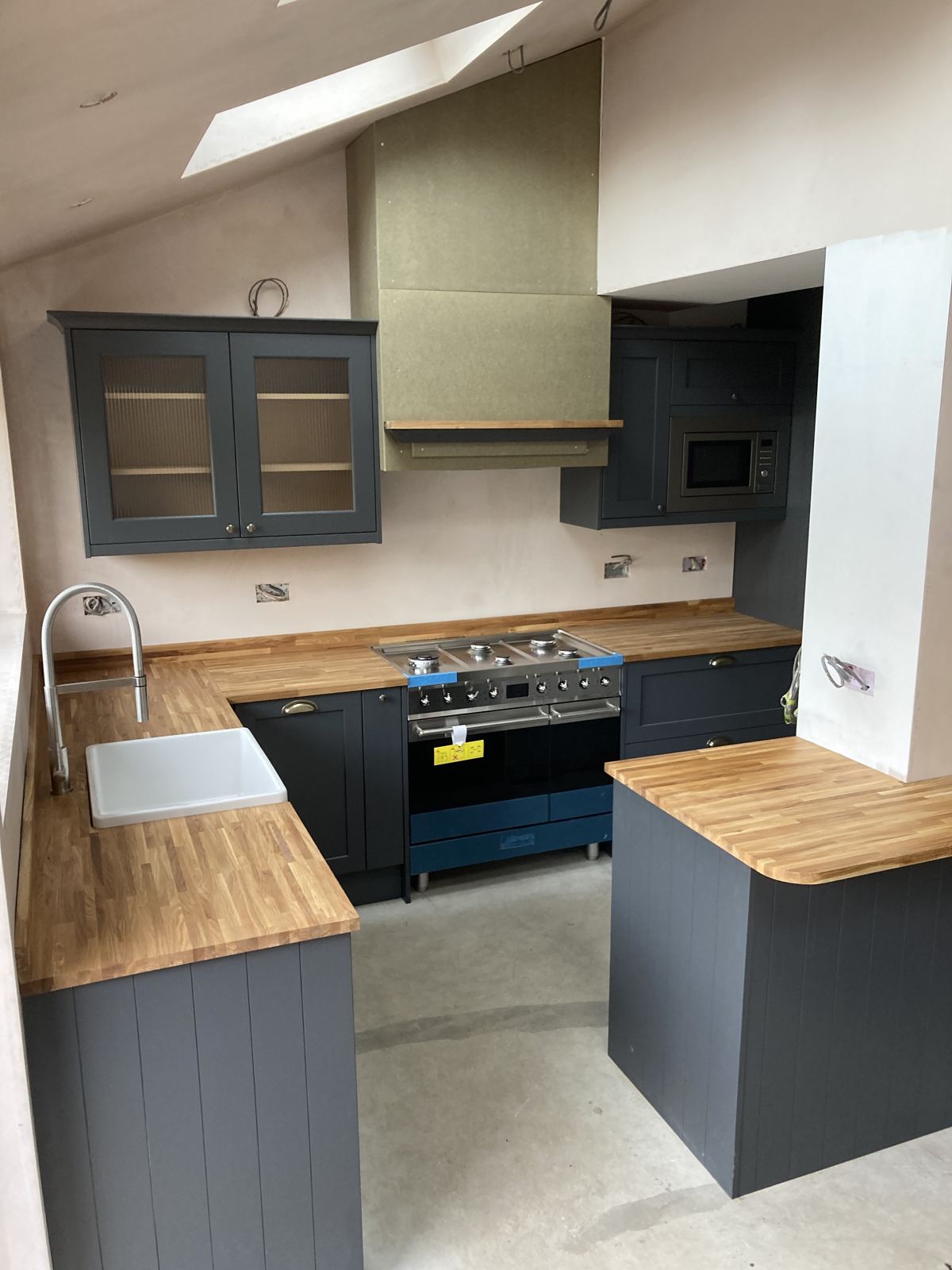 Black shaker kitchen with solid oak worktops and range cooker