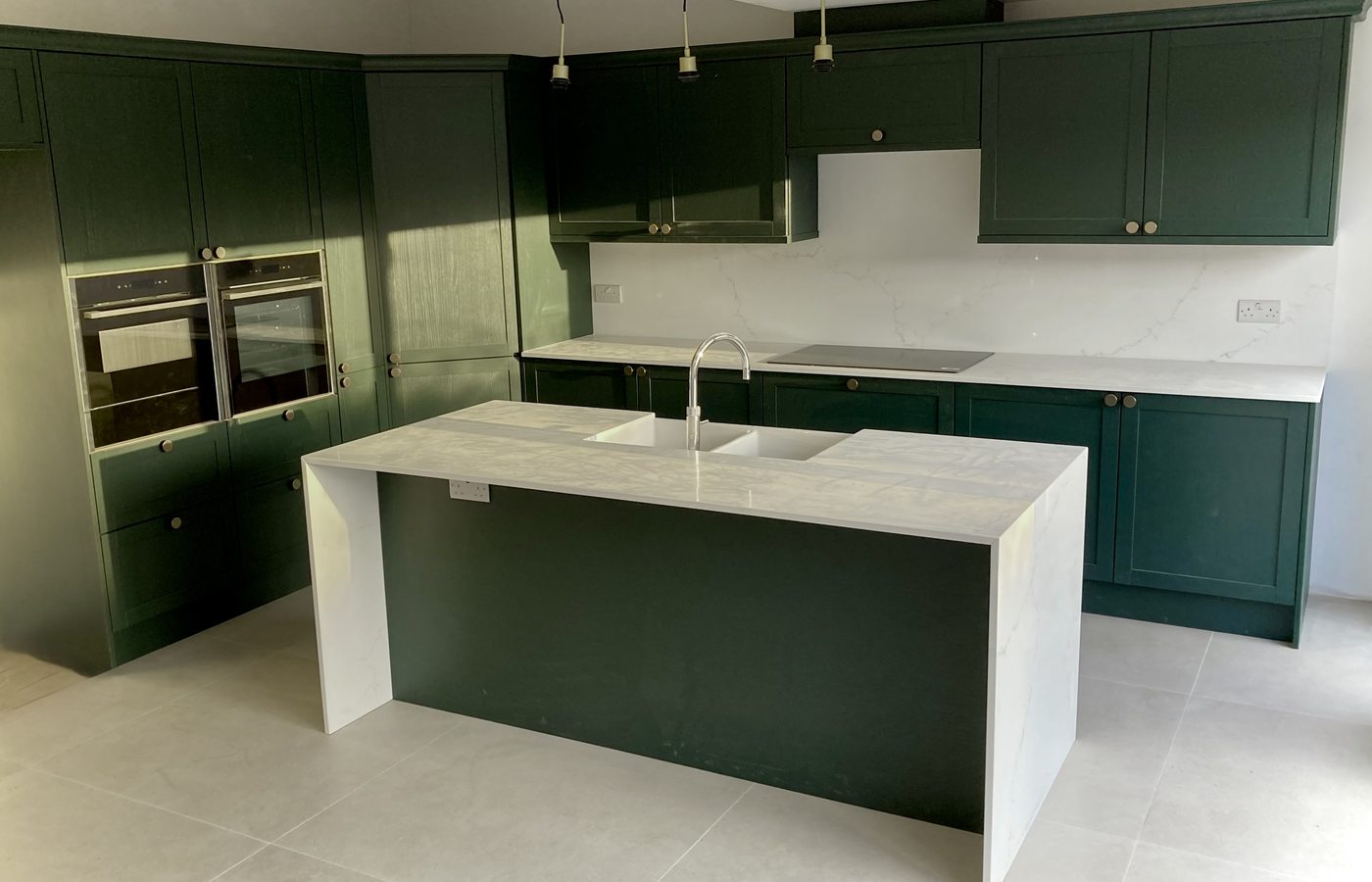 Dark green shaker kitchen with marble island — Fitted Homes Cardiff