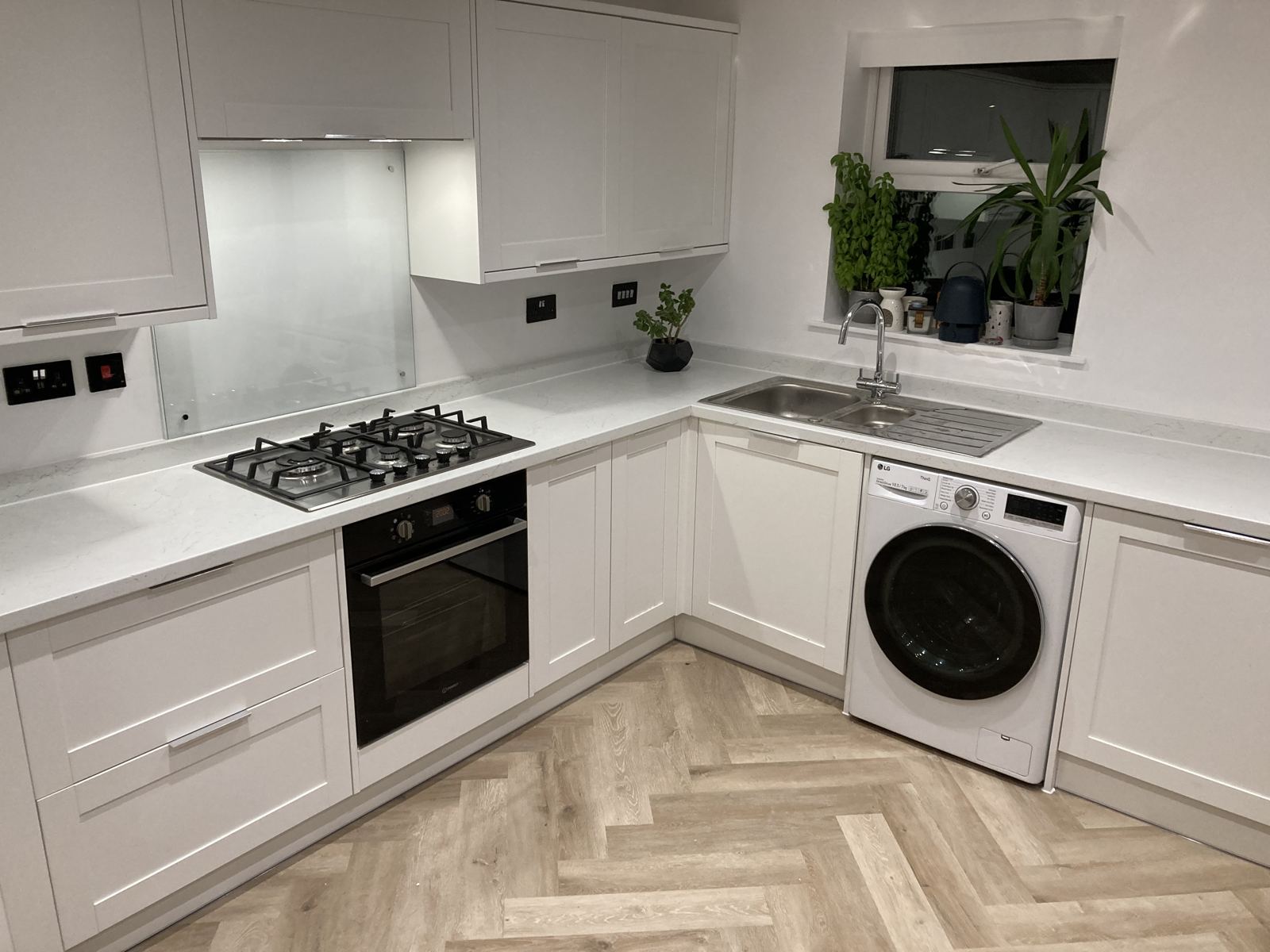 White shaker kitchen with herringbone flooring, Penarth